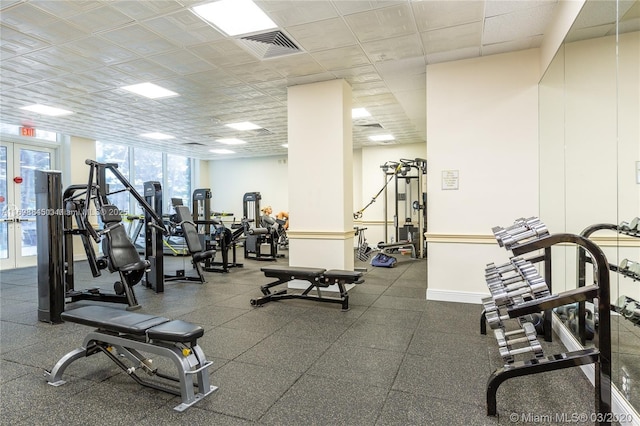 exercise room with french doors and a drop ceiling