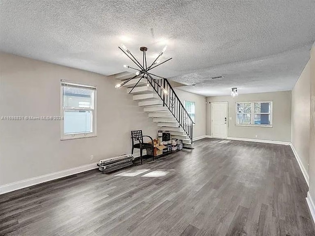 interior space with wood-type flooring, a textured ceiling, and a healthy amount of sunlight