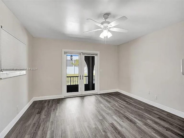 spare room featuring ceiling fan, french doors, and dark wood-type flooring