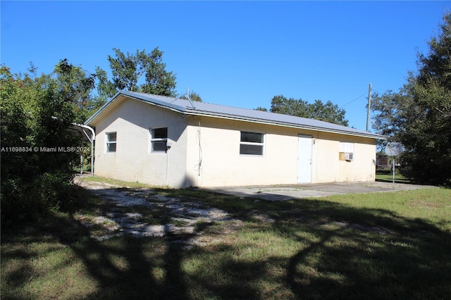 rear view of house featuring a yard