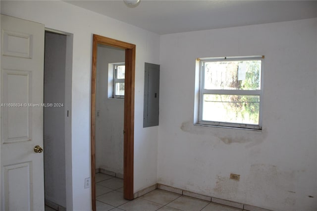 spare room featuring light tile patterned floors and electric panel