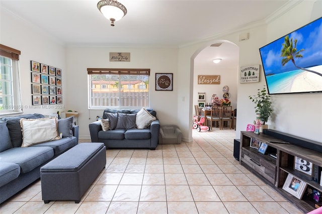 living room featuring a healthy amount of sunlight, light tile patterned floors, and ornamental molding