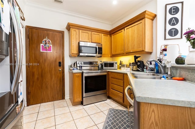 kitchen featuring sink, light tile patterned flooring, crown molding, and stainless steel appliances