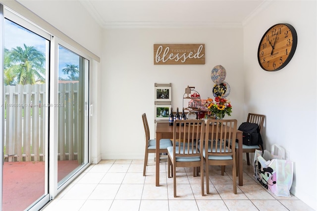 dining area with light tile patterned floors and ornamental molding