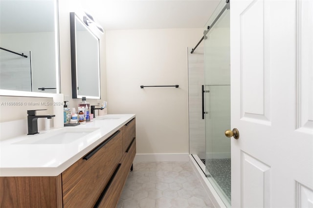 bathroom with tile patterned flooring, vanity, and a shower with door