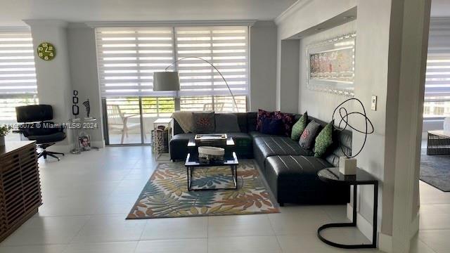 living room featuring plenty of natural light and crown molding