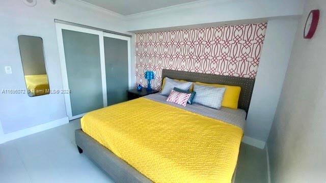 bedroom featuring a closet and crown molding