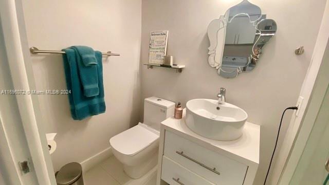 bathroom with tile patterned floors, vanity, and toilet