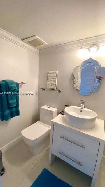 bathroom featuring tile patterned flooring, vanity, toilet, and crown molding