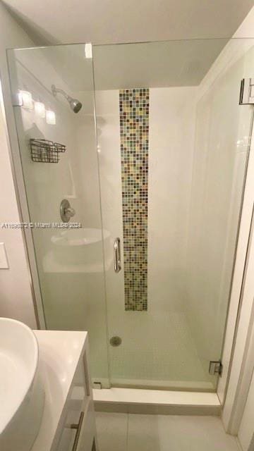 bathroom featuring vanity and an enclosed shower