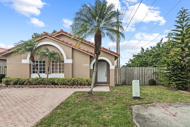 mediterranean / spanish-style house featuring a front lawn