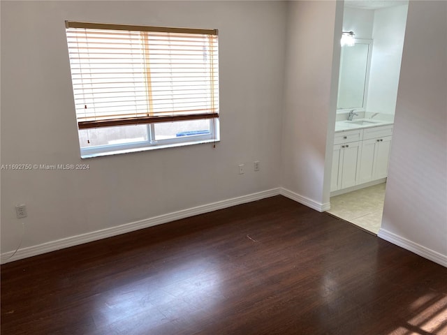 spare room with light hardwood / wood-style flooring and sink