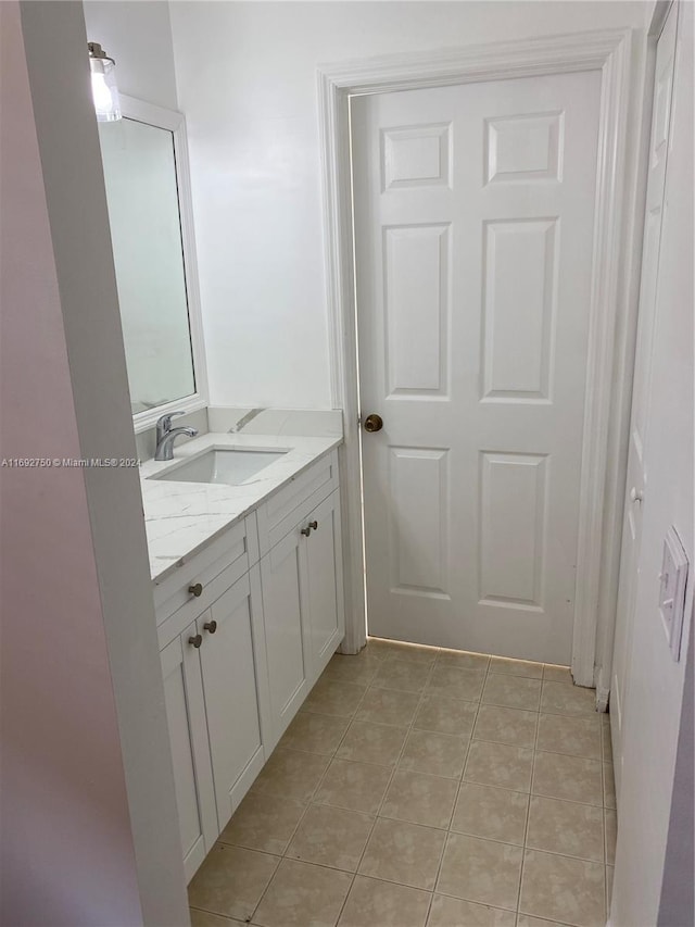 bathroom featuring tile patterned flooring and vanity