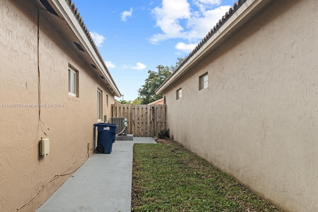 view of side of home with central AC