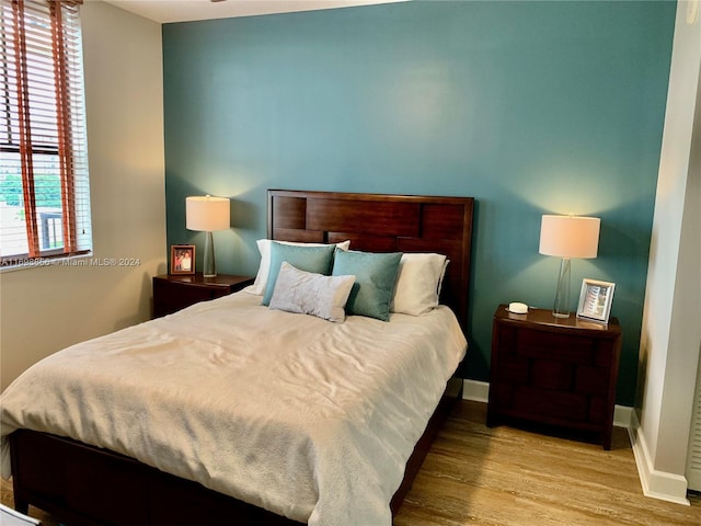 bedroom featuring light hardwood / wood-style floors and multiple windows