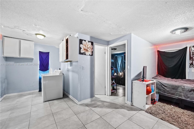 interior space with a textured ceiling and washer / dryer