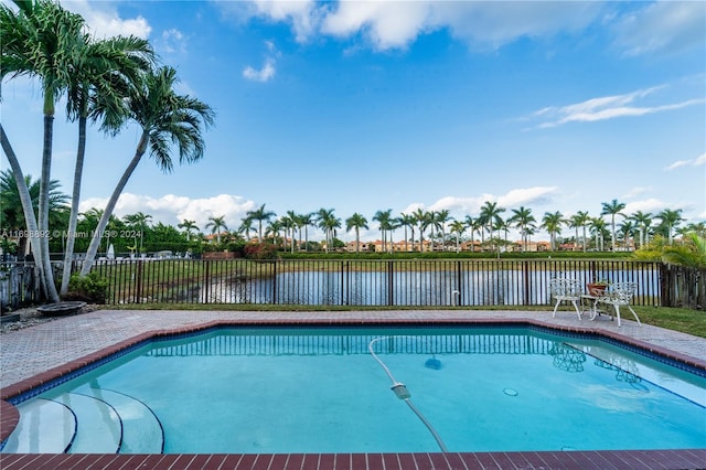 view of swimming pool featuring a water view