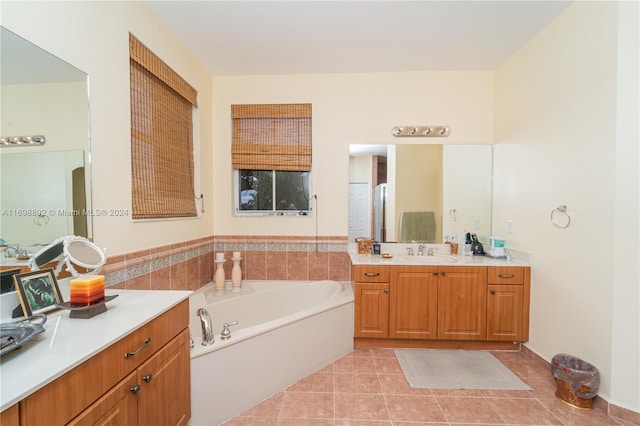 bathroom featuring tile patterned flooring, vanity, and a bath