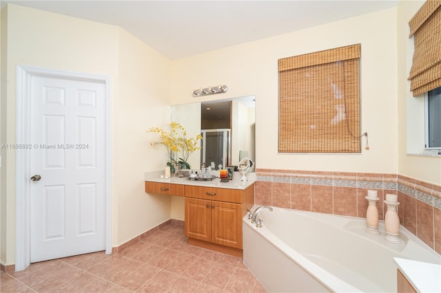 bathroom featuring tile patterned floors, vanity, and a bathtub