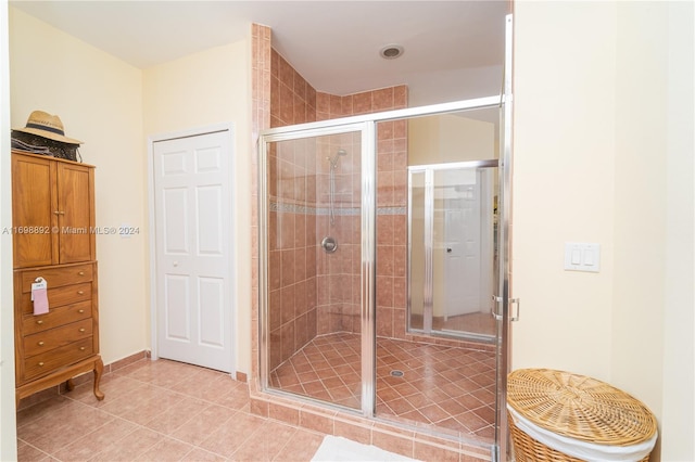 bathroom featuring tile patterned floors and an enclosed shower