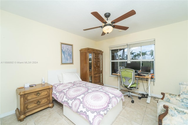 bedroom with ceiling fan and light tile patterned floors