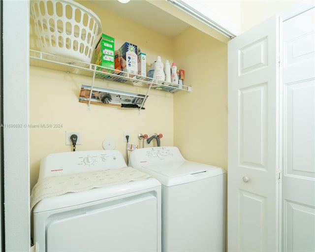 washroom with washing machine and clothes dryer