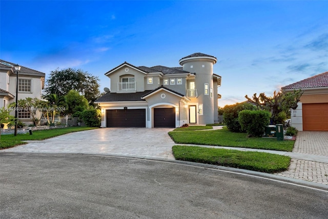 view of front of property with a garage and a front lawn