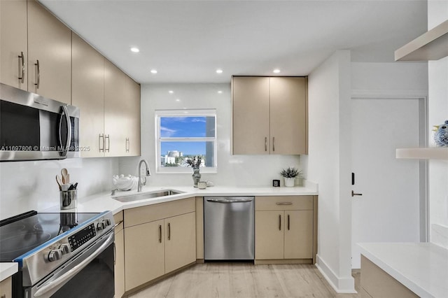 kitchen featuring light hardwood / wood-style floors, sink, light brown cabinets, and stainless steel appliances