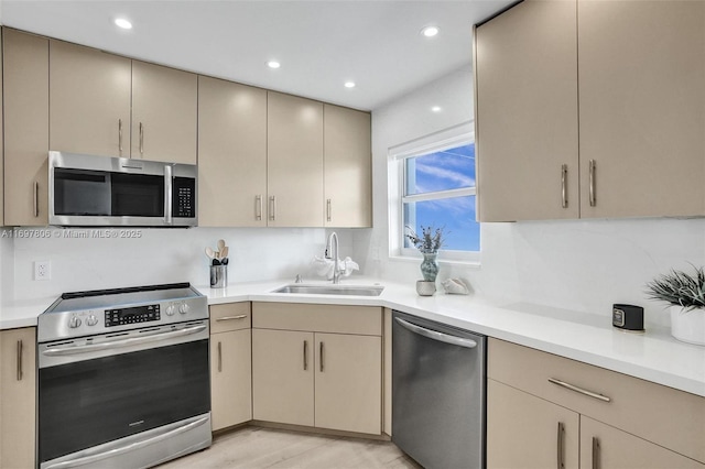 kitchen featuring sink, stainless steel appliances, and light hardwood / wood-style floors