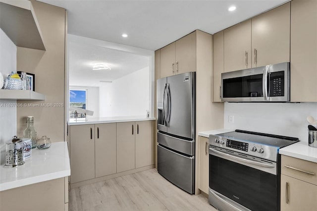 kitchen with backsplash, cream cabinets, stainless steel appliances, and light hardwood / wood-style floors