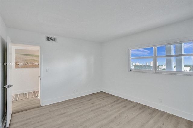 empty room with light hardwood / wood-style flooring