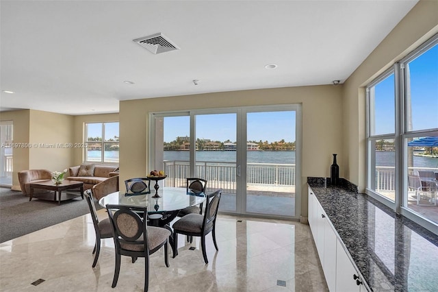 dining area featuring a water view