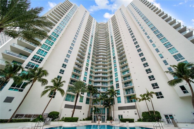 view of building exterior featuring a community pool