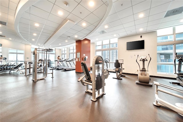 exercise room featuring a drop ceiling and plenty of natural light