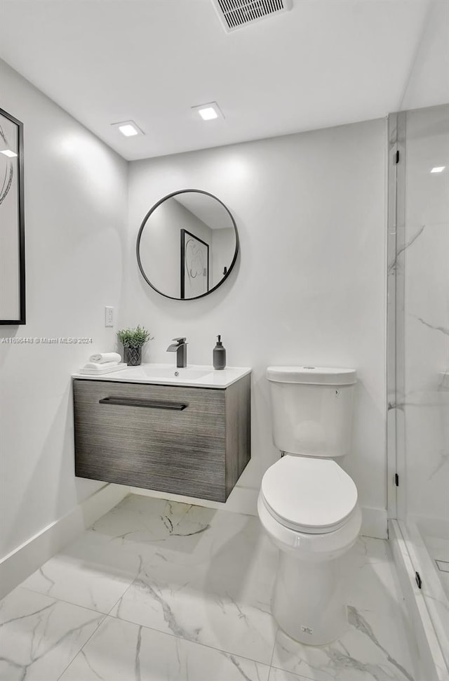 bathroom featuring vanity, toilet, and a shower