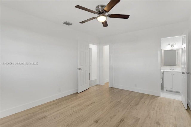 unfurnished bedroom with ensuite bathroom, light hardwood / wood-style flooring, ceiling fan, and sink