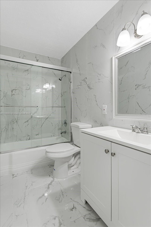 full bathroom with shower / bath combination with glass door, vanity, and toilet