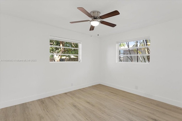 unfurnished room featuring light hardwood / wood-style flooring, ceiling fan, and a healthy amount of sunlight