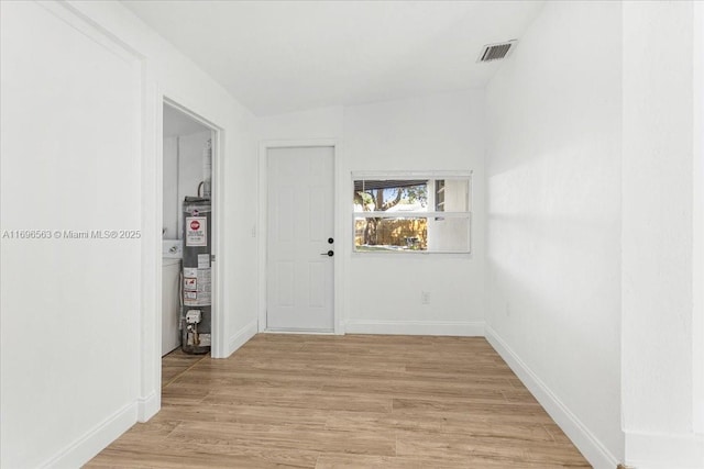 hall featuring water heater and light wood-type flooring