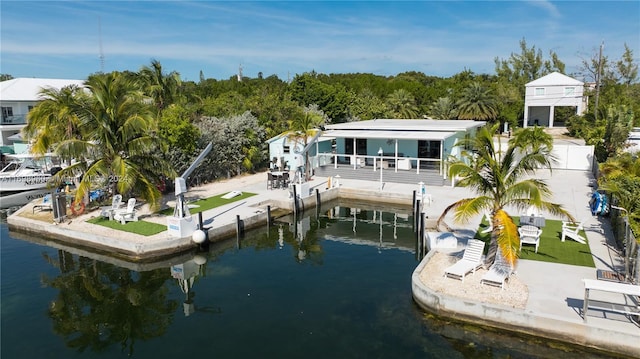 dock area with a patio area and a water view