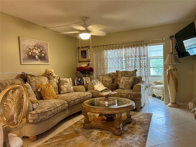 tiled living room featuring ceiling fan and a textured ceiling