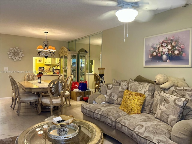 tiled living room featuring ceiling fan with notable chandelier and a textured ceiling