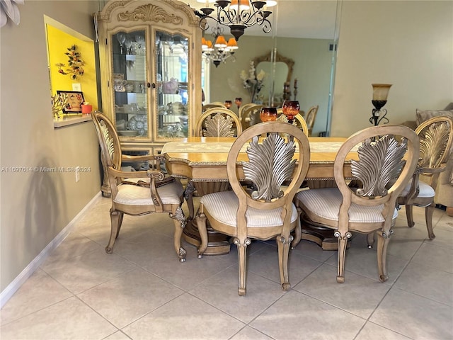 dining room with a notable chandelier and light tile patterned flooring