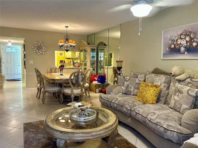 tiled living room featuring a chandelier and a textured ceiling