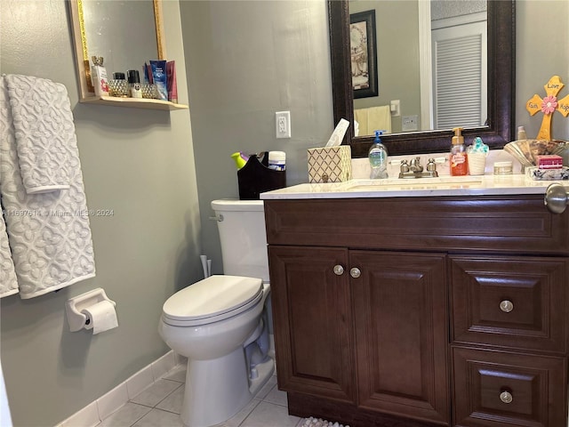 bathroom with tile patterned flooring, vanity, and toilet