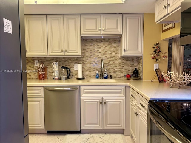 kitchen featuring backsplash, light tile patterned floors, sink, and appliances with stainless steel finishes