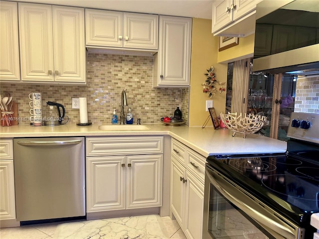 kitchen with sink, stainless steel appliances, and tasteful backsplash