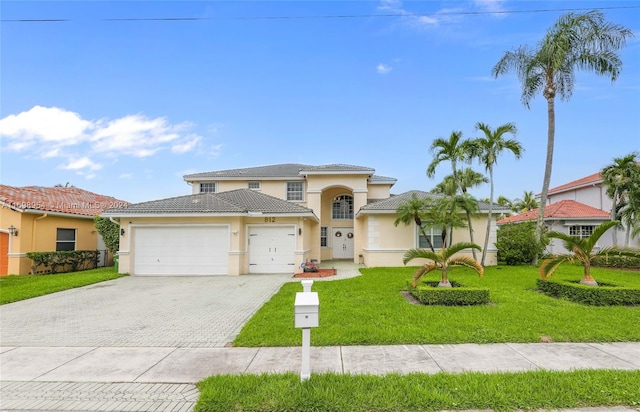 mediterranean / spanish home with a front yard and a garage