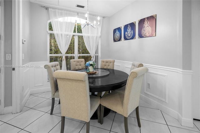 dining area featuring light tile patterned floors and a chandelier