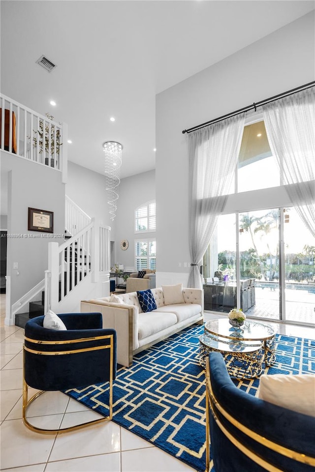 living room with tile patterned flooring and a notable chandelier